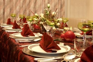 Christmas dinner table with flowers and red napkins